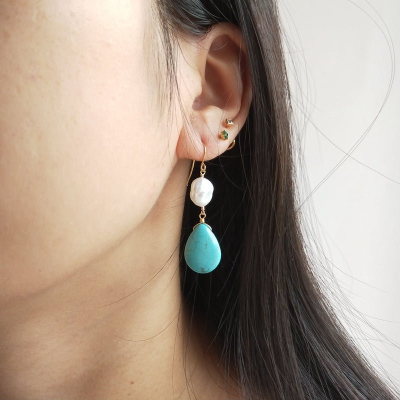 Closeup of Ear Wearing a Baroque Turquoise and Pearl Earrings